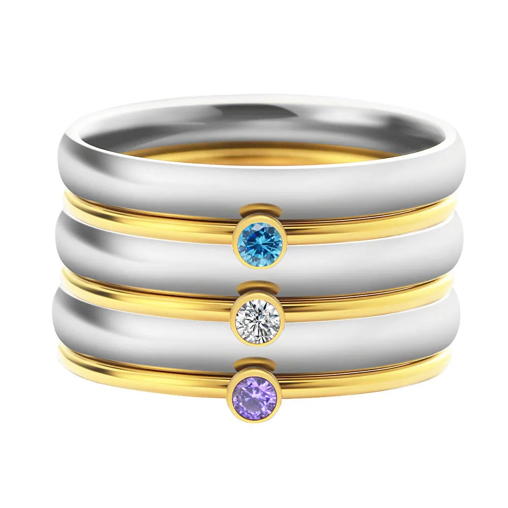 Close-up of a geometric engraved December birthstone ring in gold electroplate on titanium steel.