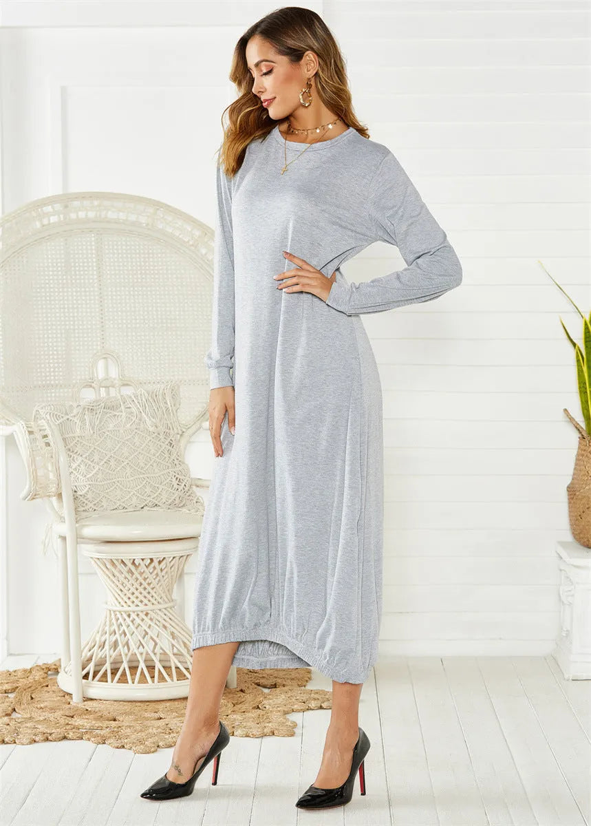 A grey loose-fitting long lantern dress with long sleeves and a crew neckline, laid flat.