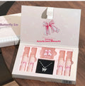 Butterfly Box cosmetics set showing four matte lip muds, pink powder blusher and necklace