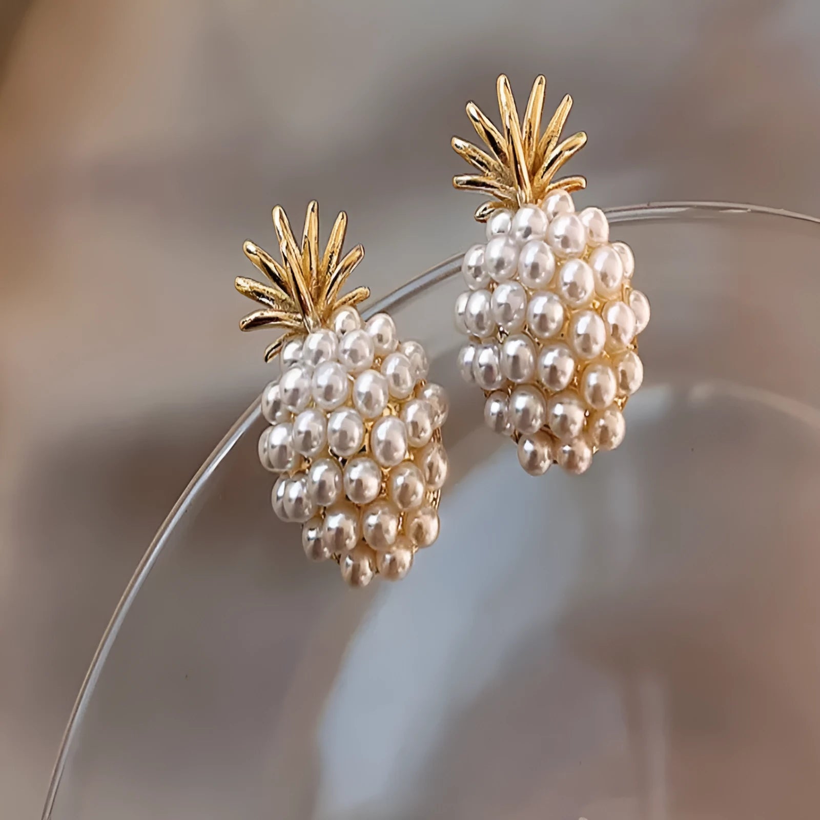 Korean-style women's drop earrings with a pineapple starfish pearl design in alloy with stone inlay.