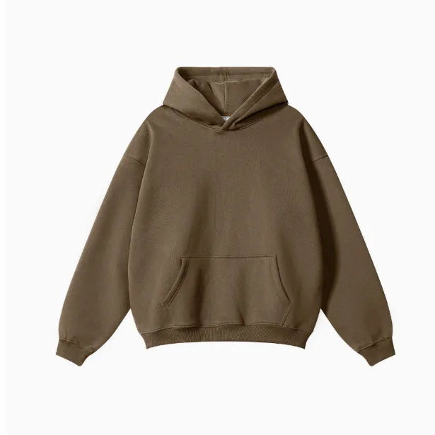 Man wearing a loose-fit grey cotton terry hooded sweater with drop-shoulder sleeves.