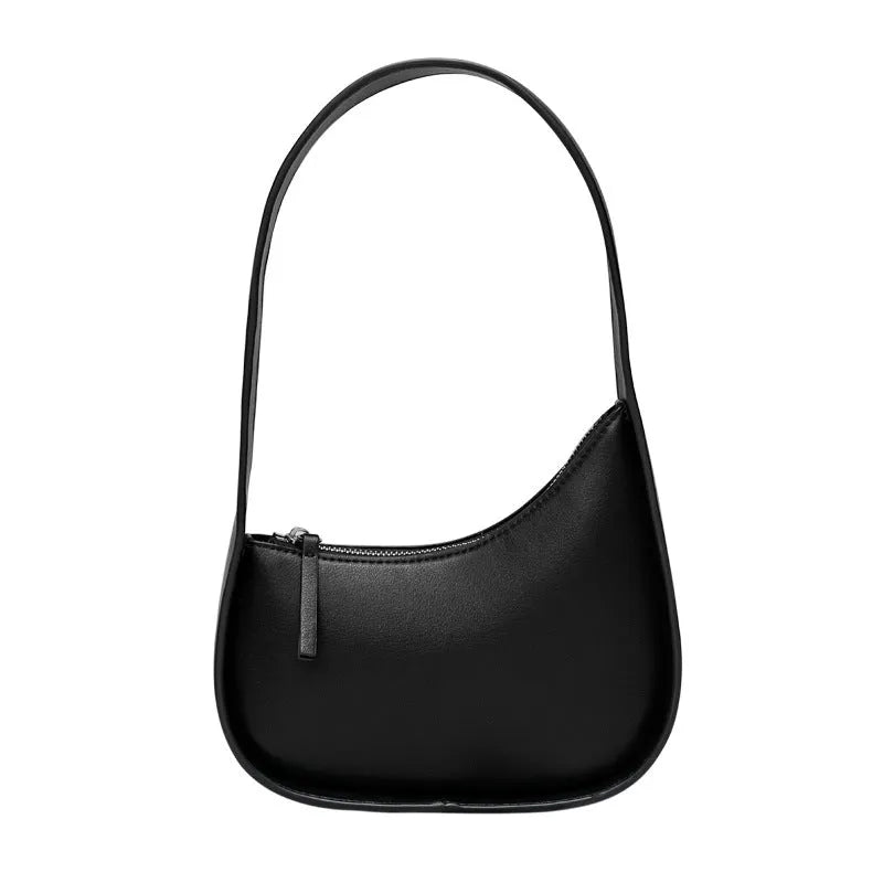 Women's half moon shaped leather shoulder bag in light brown with an adjustable wide strap.