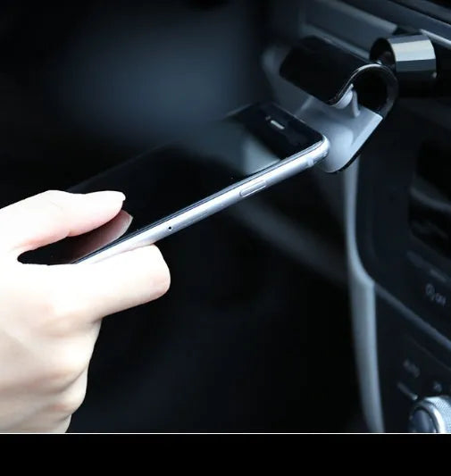 Black universal car phone holder with 360-degree rotation head mounted on a car air vent
