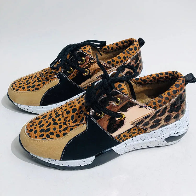 Women's black suede casual sneakers with a wedge heel on a white background