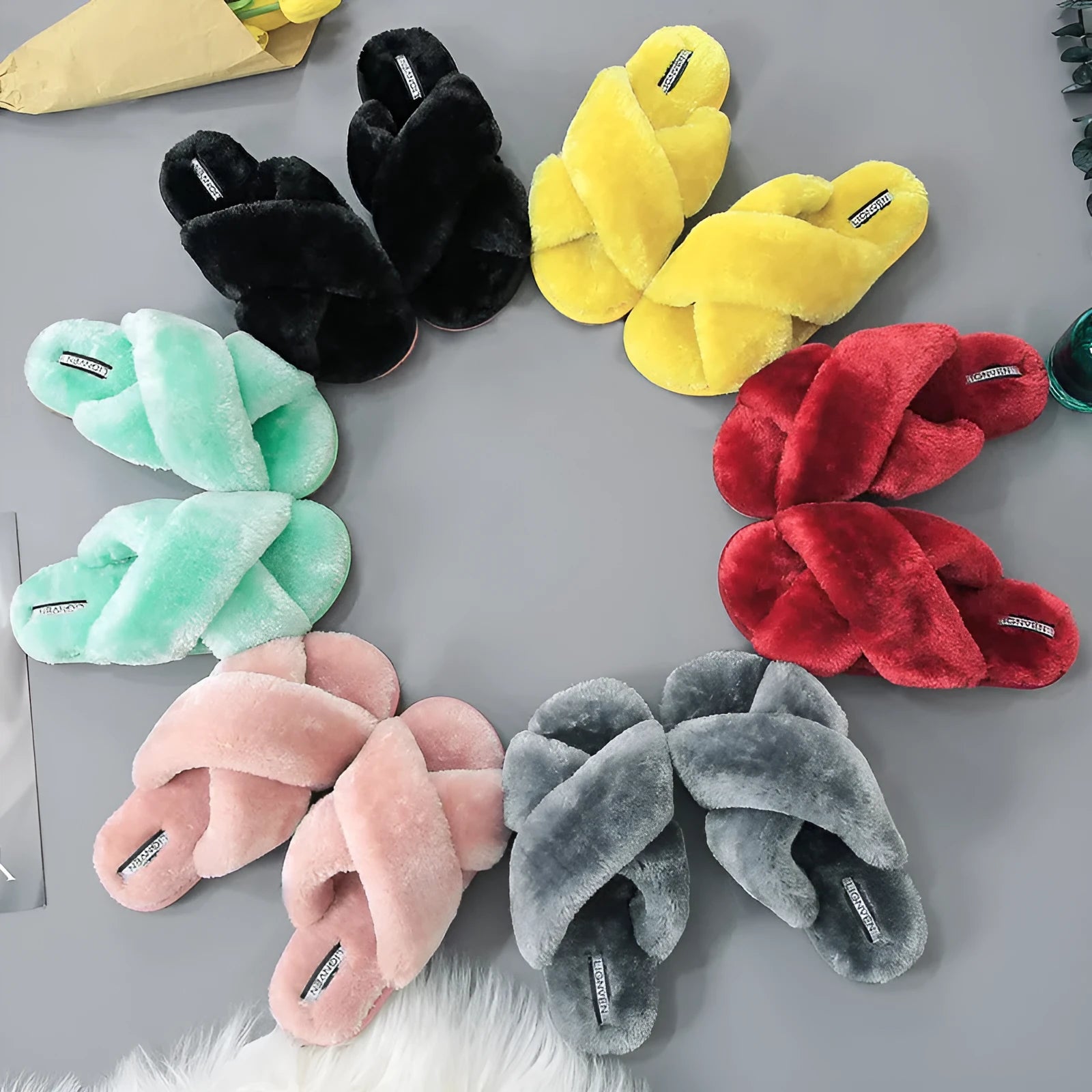 Cross open-toe fur slippers in black on a patterned non-slip sole