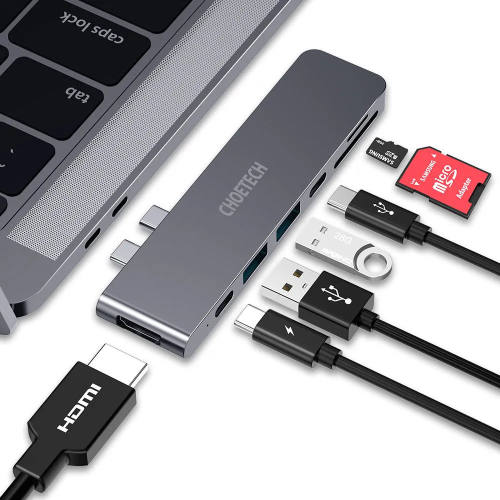 Compact aluminium USB-C hub adapter with SD card slot, microSD slot, two USB ports, HDMI, and charging port.