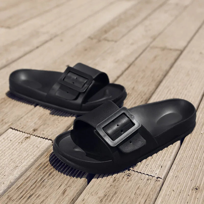 Women's grey blue buckle fastening flip-flop sandals with soft EVA sole on a white background.