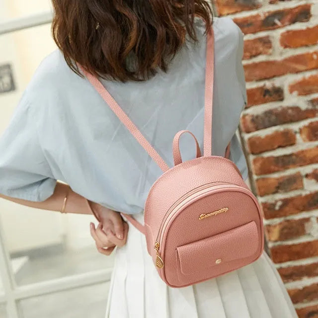 Solid colour PU leather women's small shoulder backpack with zipper, shown in available colours.