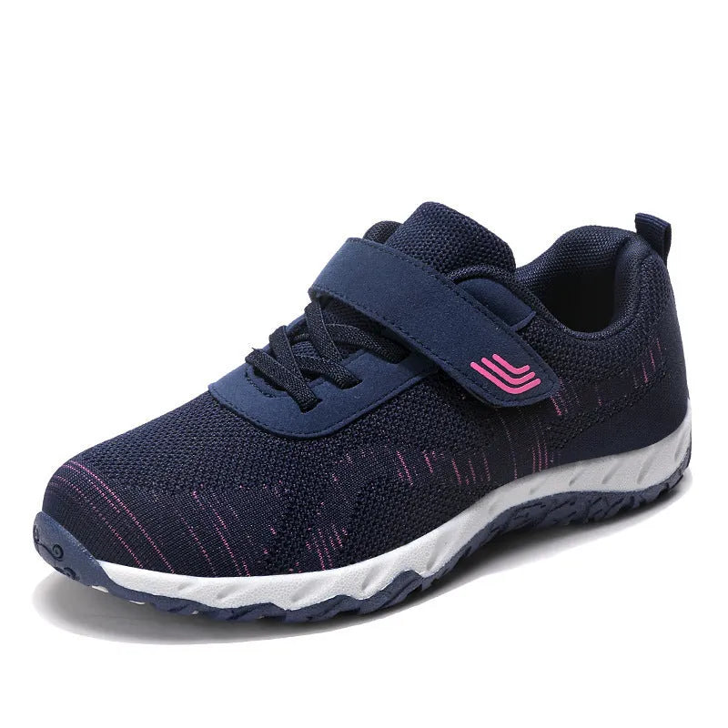Women's low-top wedge heel shoes with mesh upper and Velcro strap in a solid colour.