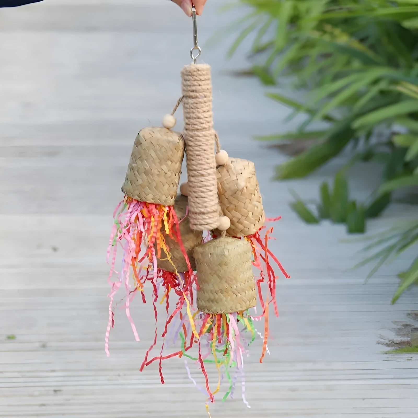 Wood and sisal parrot toy with colourful shredded paper filling, size 15 by 35 centimetres