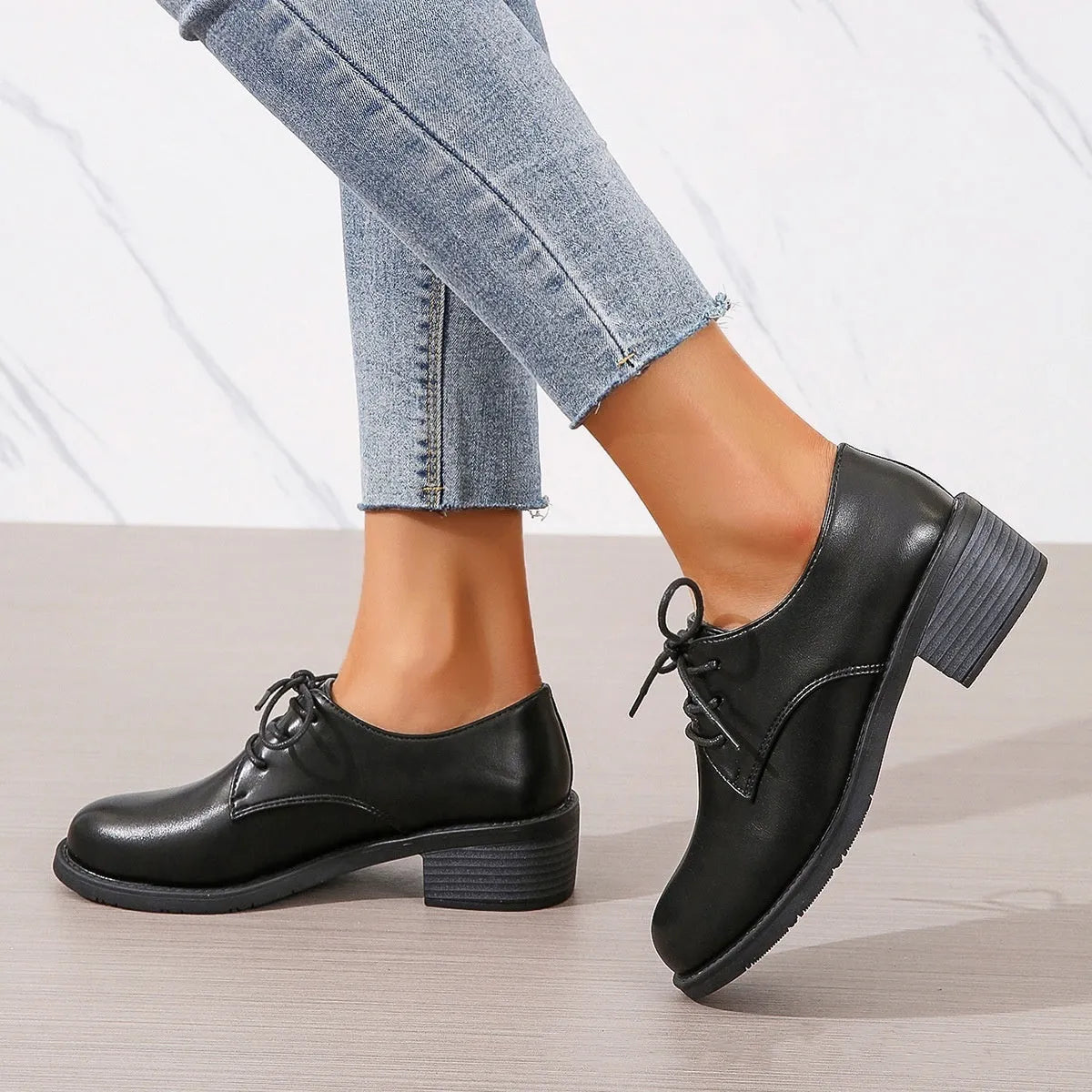 Black women's low-top shoes with a chunky thick heel and rubber sole.