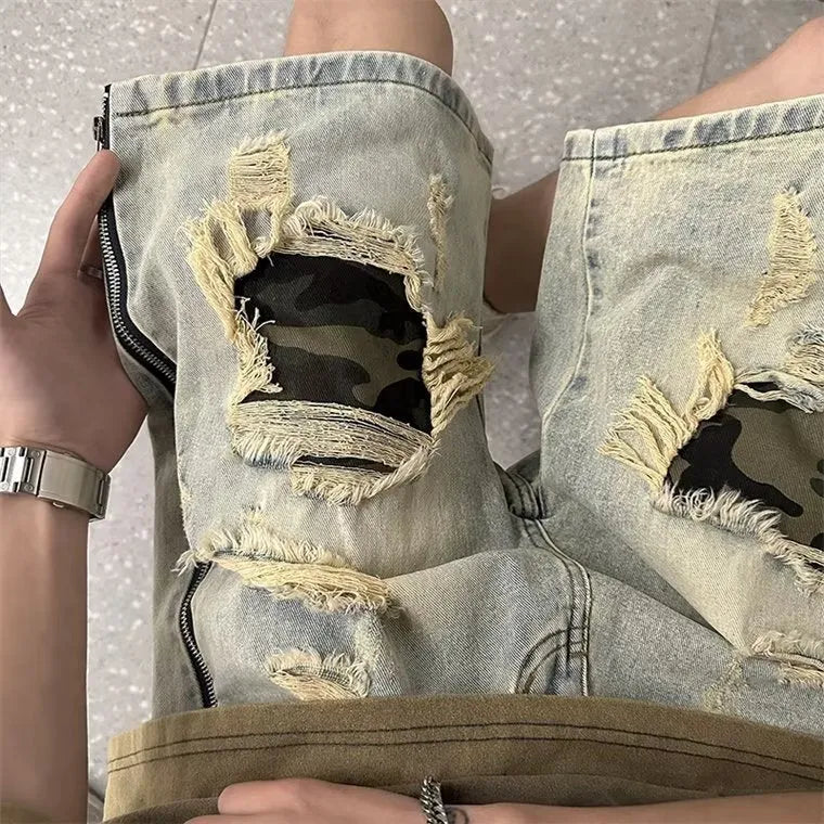 Men's yellow mud camouflage ripped denim shorts shown on a model, featuring a straight leg cut and distressed details.