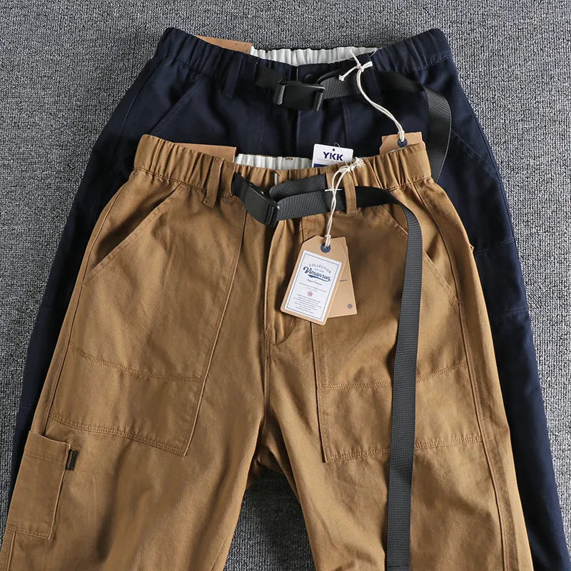 Cotton work trousers in khaki colour with mid waist design and zip fly closure