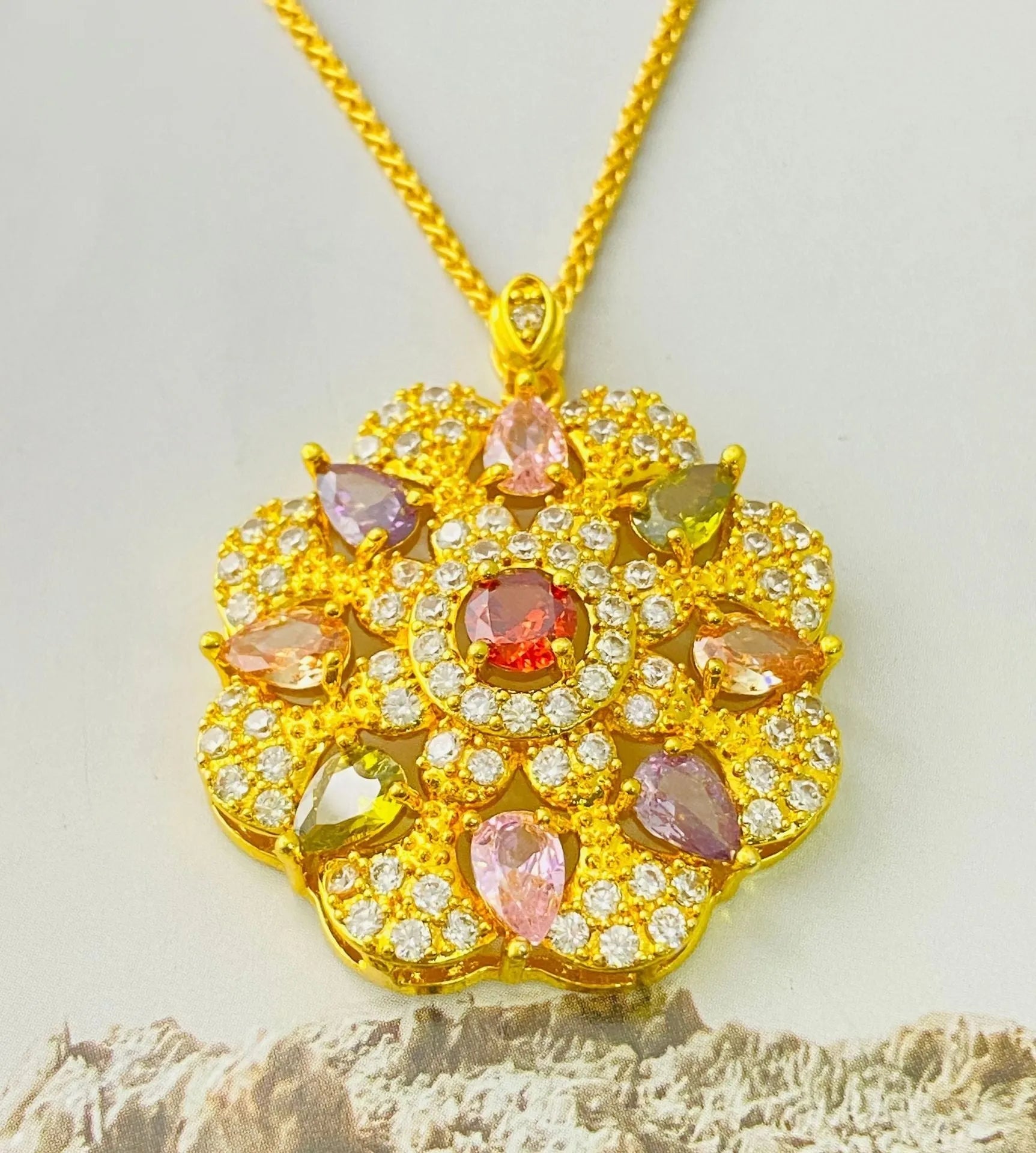 Women's flower-shaped zircon pendant necklace in gold tone on a model.