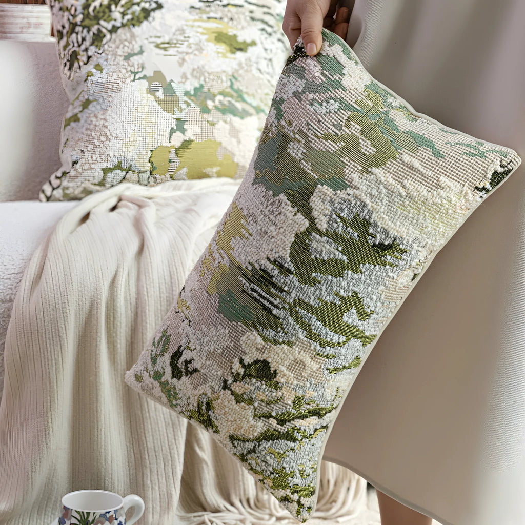 Green abstract floral wool blend decorative cushion on a neutral background.