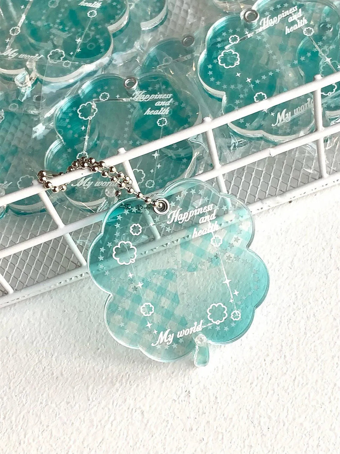 Acrylic four-leaf clover shape keychain pendant for phones in blue, green, or mint.