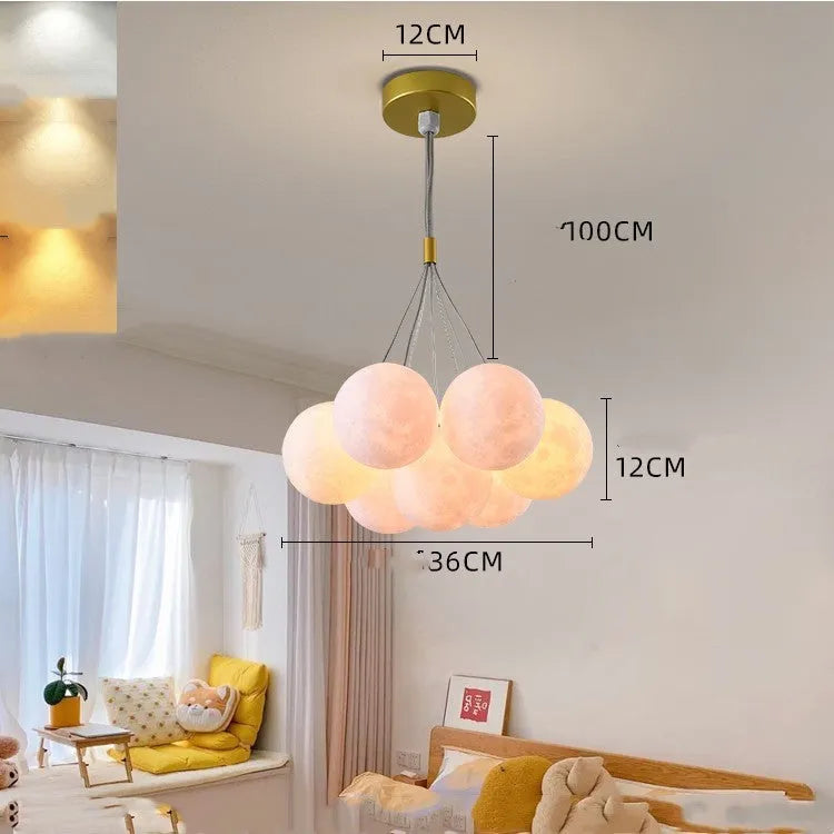Nordic fish-shaped pendant chandelier with cluster of spherical moon bubble lights in gold or black finish.