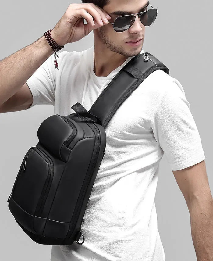 Black PVC outdoor leisure shoulder bag with internal organiser pockets and air cushion strap