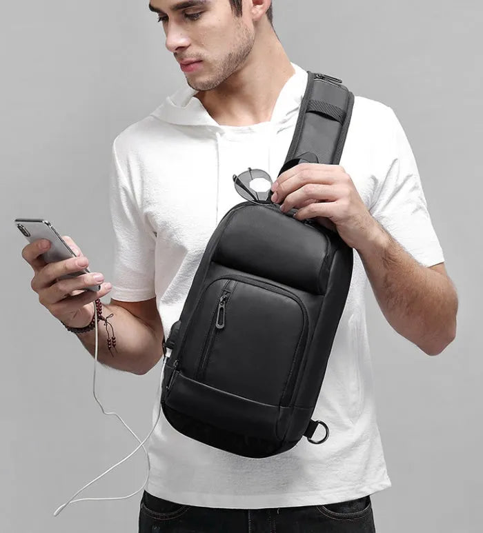 Black PVC outdoor leisure shoulder bag with internal organiser pockets and air cushion strap