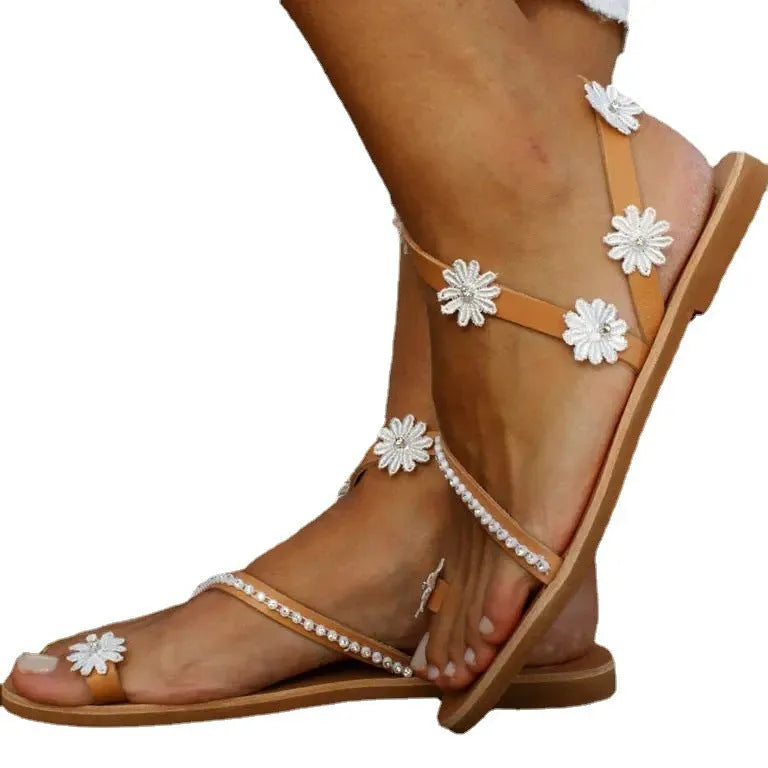 Brown ladies Roman sandals with flower decoration and flat rubber sole