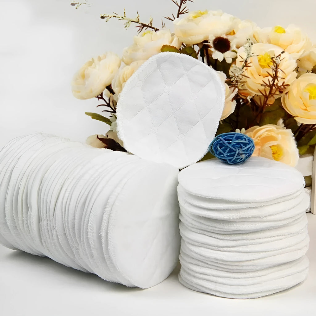 Pack of four white eco-cotton double-layer anti-galactorrhea nursing pads on a white background