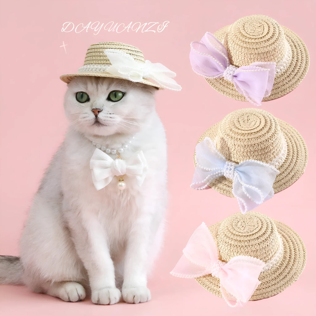 Woven straw hat for a cat with a pearl butterfly bow, shown in pink, purple, blue, or white colour options.
