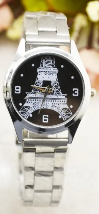 Silver Eiffel Tower engraved dial on a stainless steel wrist watch with a silver-toned strap.