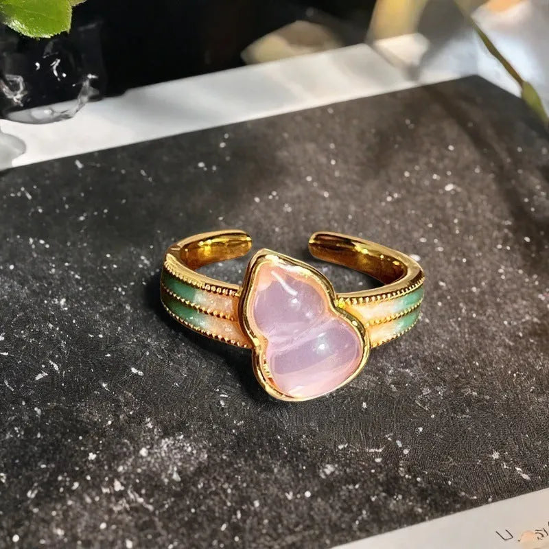 Adjustable copper vintage gourd ring with inlaid zircon stones showing floral and bow design elements