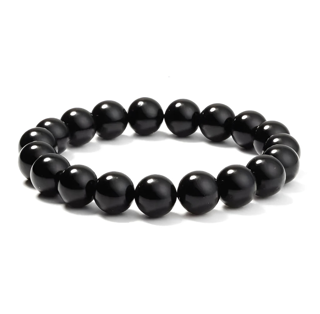 Close-up of a women's geometric bracelet with black agate beads on a black elastic cord.
