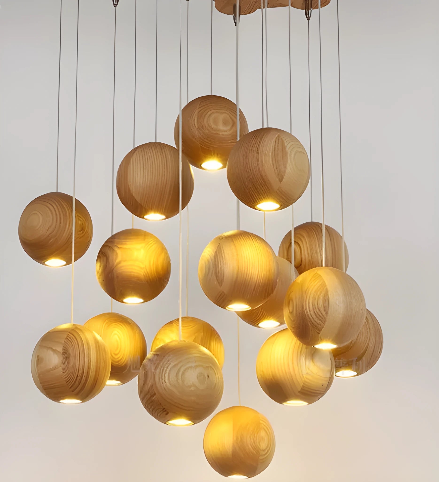 Nordic style solid wood ball chandelier with wooden spheres hanging from a wood disc ceiling plate.