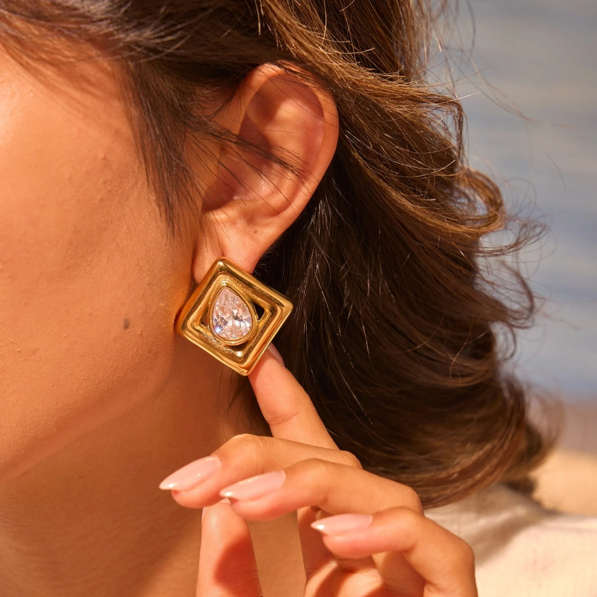 Geometric water drop shaped stud earrings with zircon inlay and gold electroplated finish