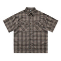 Men's black and brown plaid short sleeve shirt with embroidered letter detailing on the front