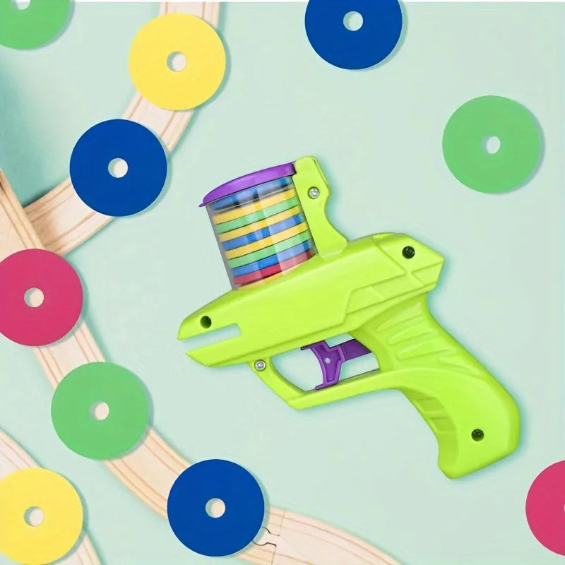 Green or purple plastic cat toy launcher with soft foam discs for interactive play.