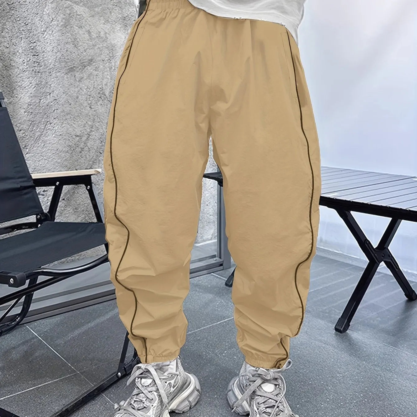 Men's loose blue bamboo fibre cropped sports trousers on a grey background