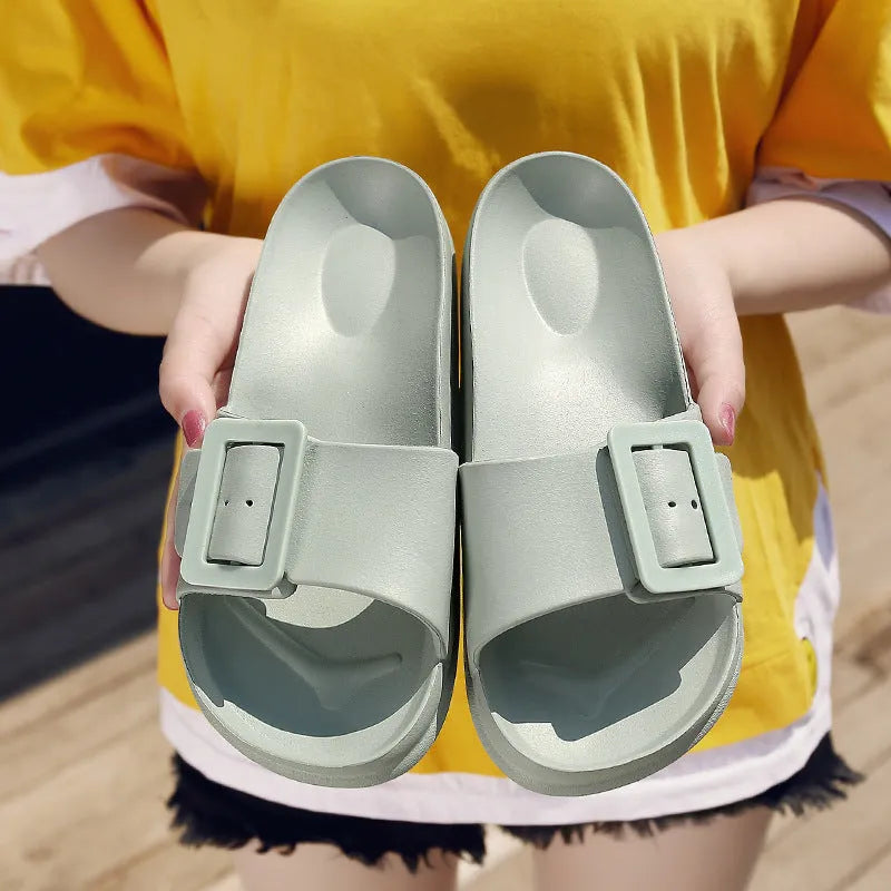 Women's grey blue buckle fastening flip-flop sandals with soft EVA sole on a white background.