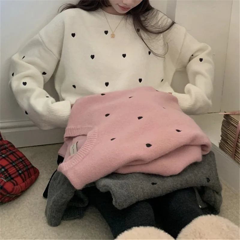 Women's loose grey acrylic pullover sweater with embroidery on the front, long sleeves, and a crew neck.