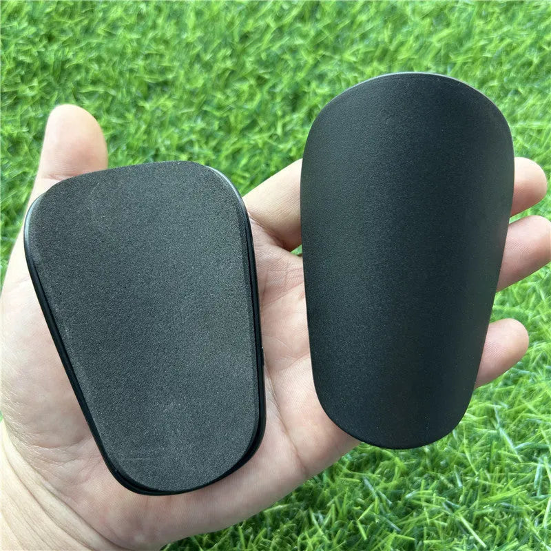 Extra small mini plastic football shin guards in black and white 8x5cm sizes