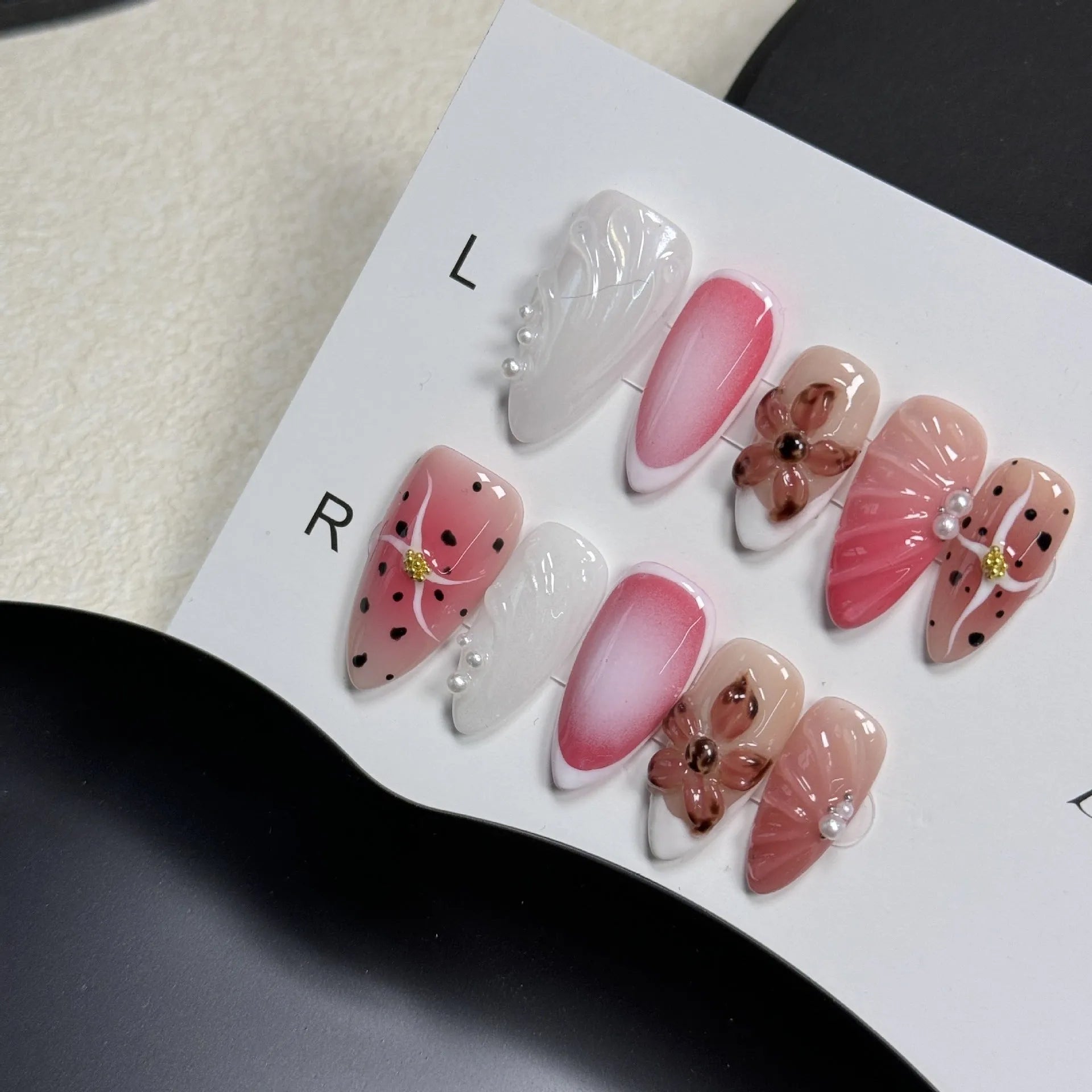 Hand-painted three-dimensional carved nail beauty patches showing embossed and candy patterns on almond-shaped nails