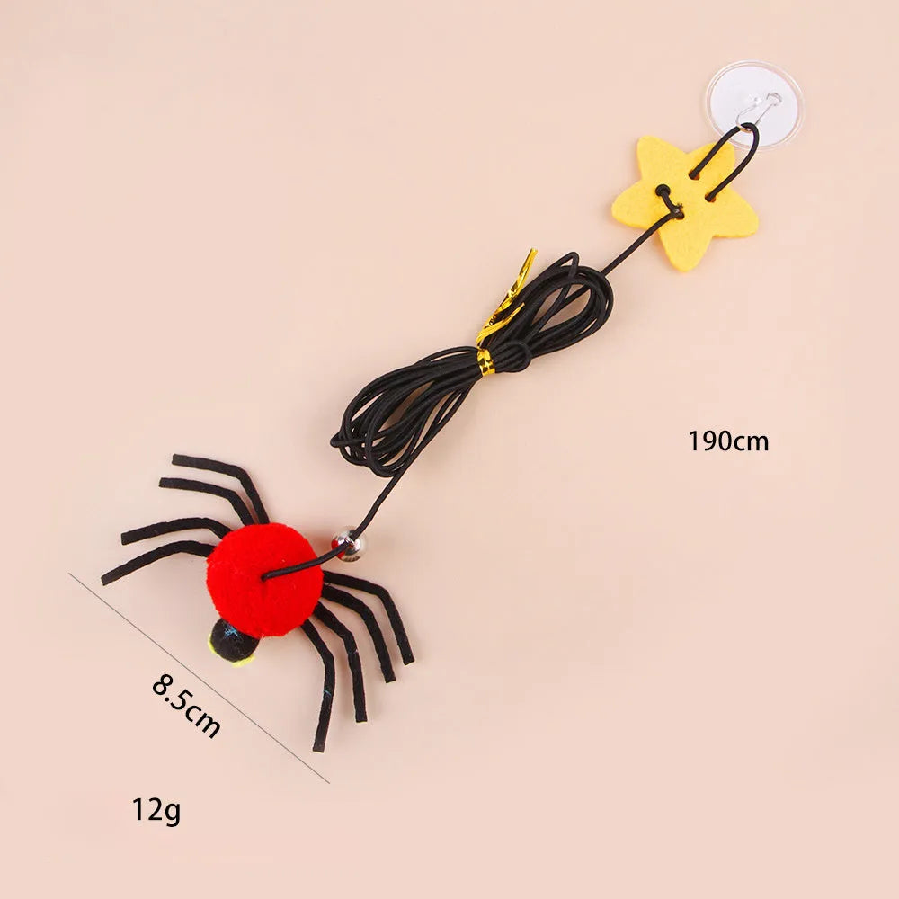 Red and yellow door-hanging cat toy with elastic rope, feather, bell and spider attachment for indoor feline play