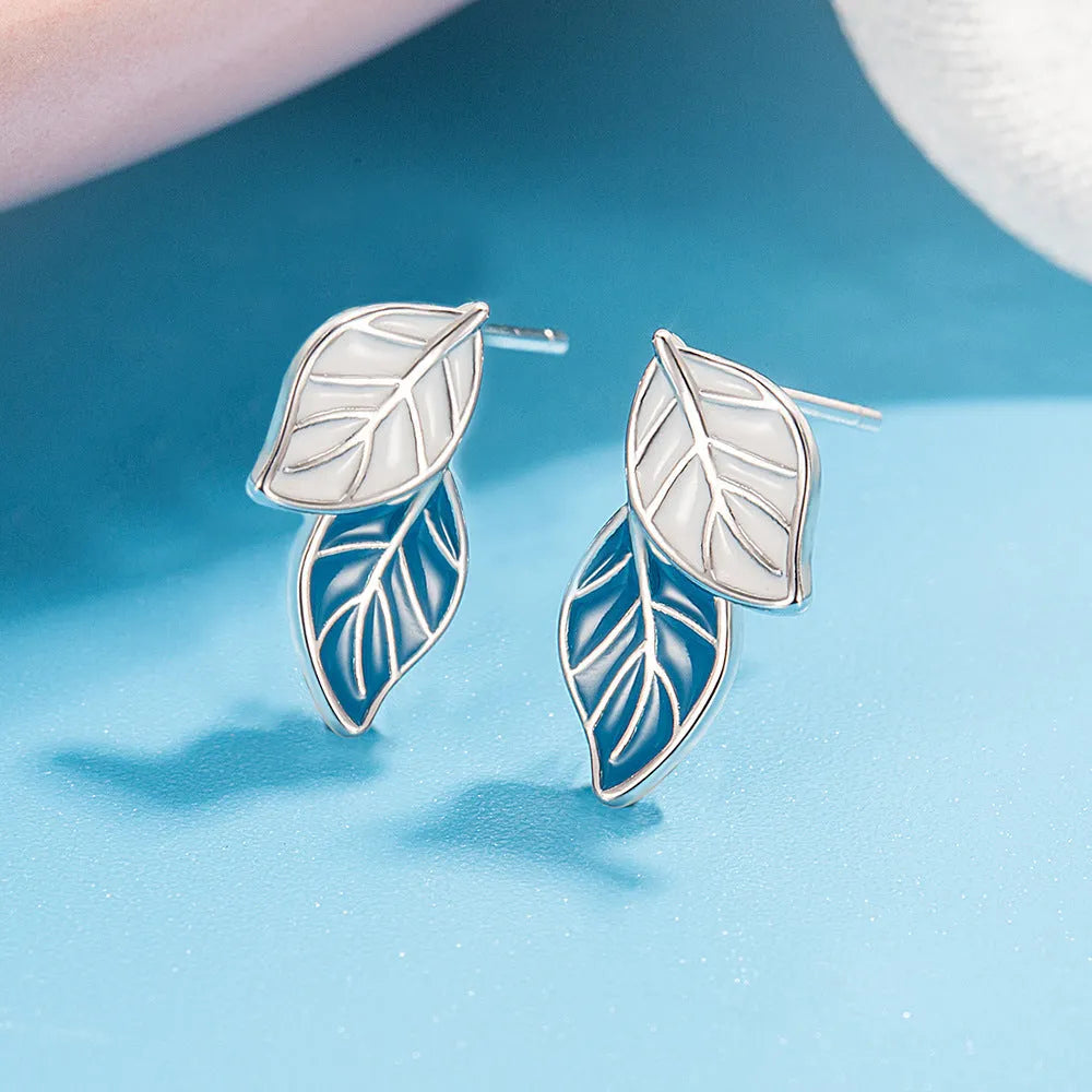 White gold plated copper leaf-shaped stud earrings for women on white background