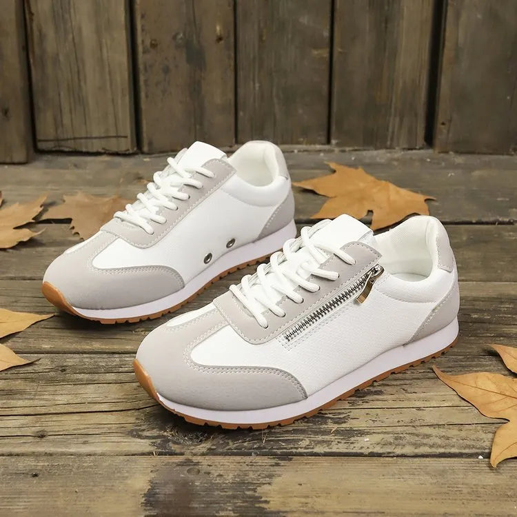 Women's flat-heeled shoes in artificial PU, available in Champagne, Gray, and White colours with a rubber sole.