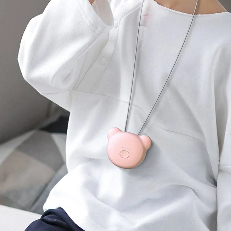 Mini USB portable air purifier necklace in pink, showing compact wearable design.