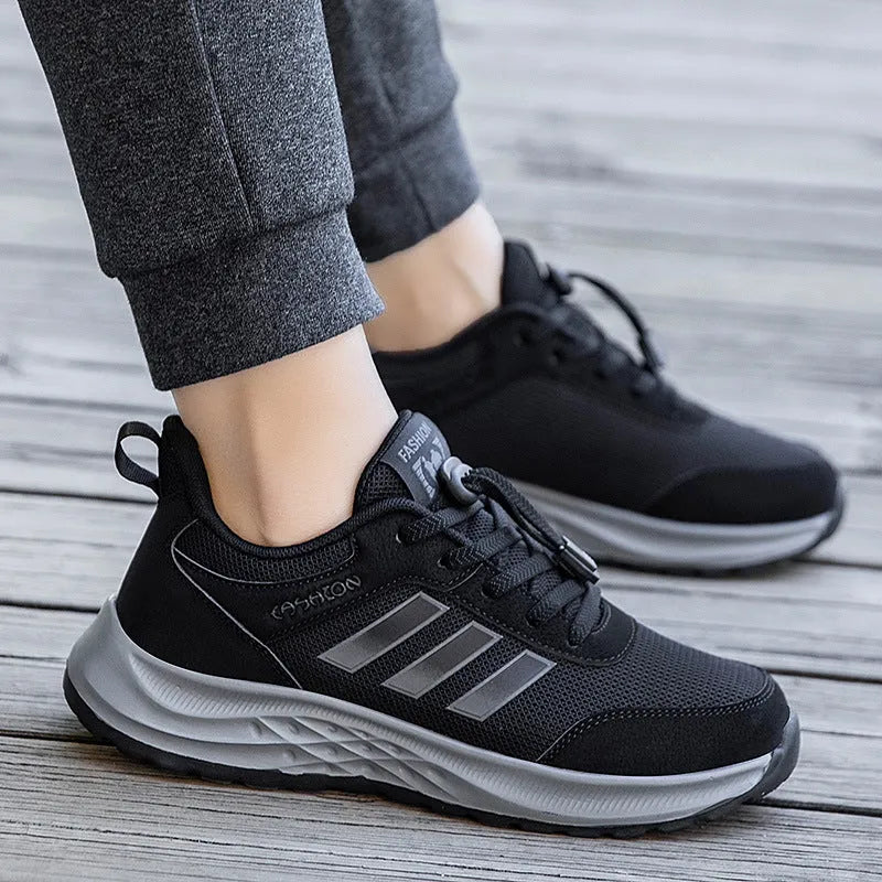 Casual unisex slip-on shoe with mesh upper and black elastic band fastening on a non-slip sole.