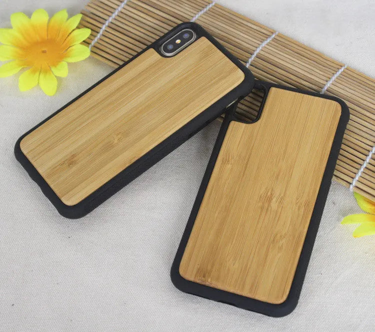 Wooden iPhone case with carbonised bamboo back and black TPU sides on a wooden table.