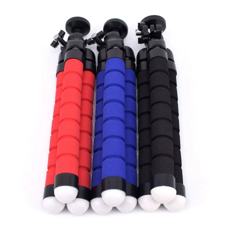 Black flexible octopus tripod with bent legs wrapped around a pole, holding a smartphone.