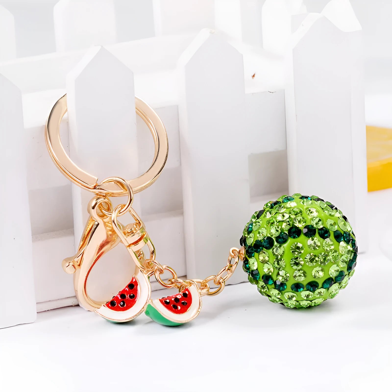 Green watermelon slice shaped zinc alloy keychain measuring 12cm long.