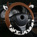 Short plush automotive steering wheel cover in black colour showing textured surface