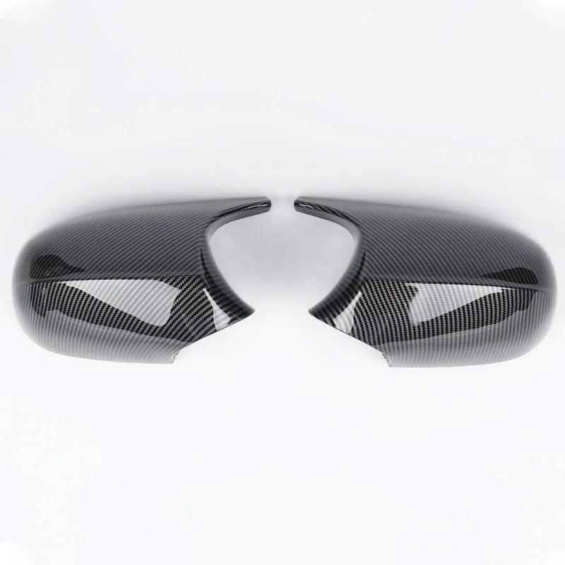Pair of black ABS plastic rearview mirror shells for BMW 3 Series E90, shown alongside original equipment part numbers.