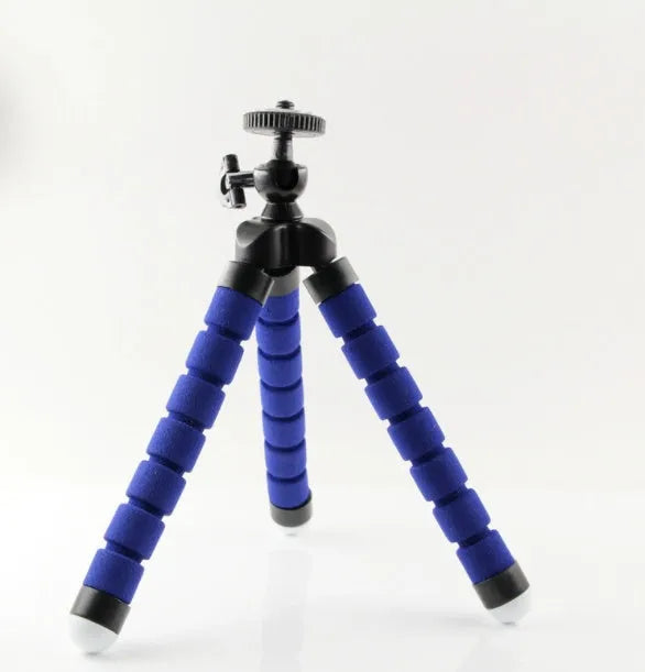 Black flexible octopus tripod with bent legs wrapped around a pole, holding a smartphone.