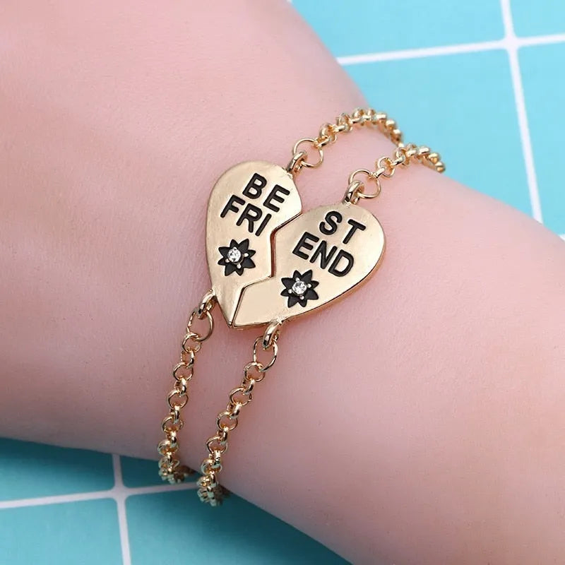 Heart shape alloy bracelet with dripping oil finish and inlaid gems in gold and silver colours